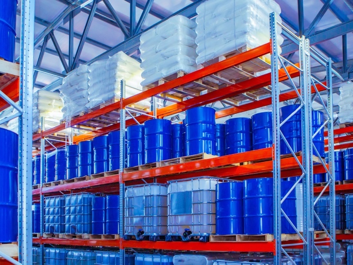 Blue barrels in a Quality Packing Services warehouse.